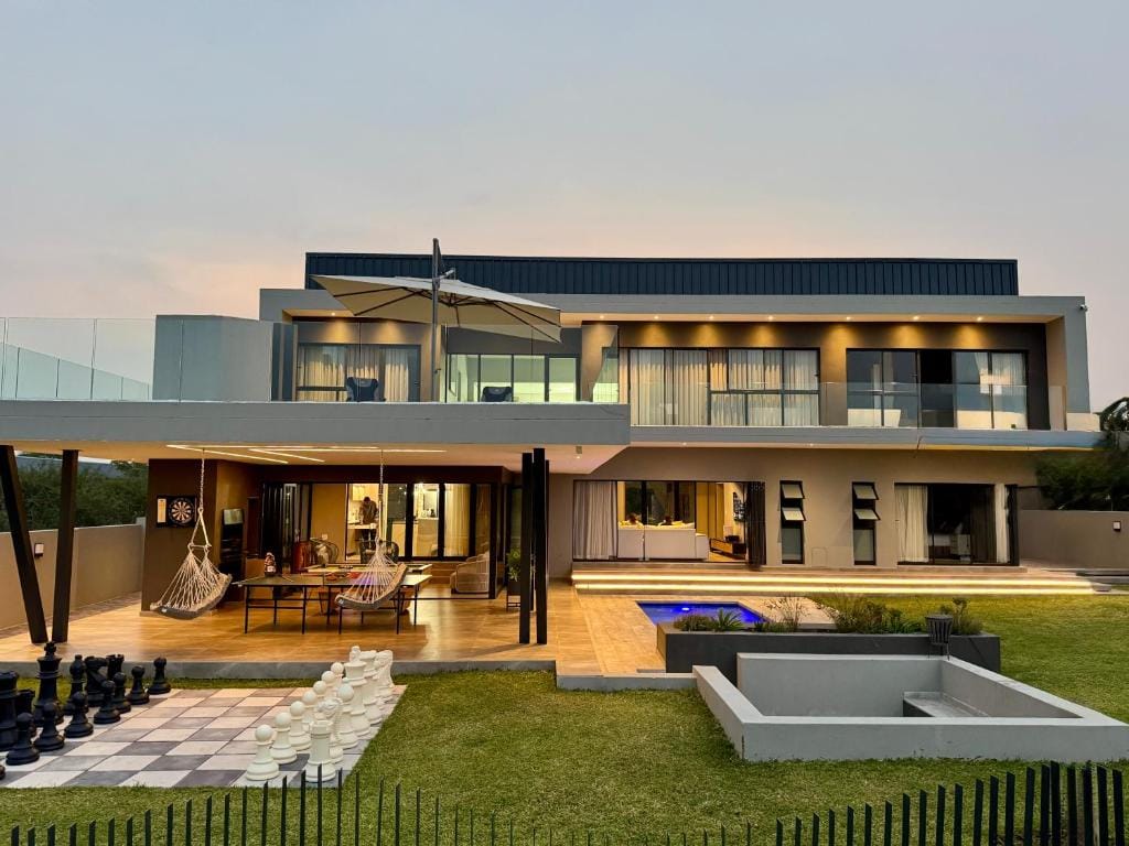 Contemporary double-storey home completed by Nelukalo RI Enterprises at dusk